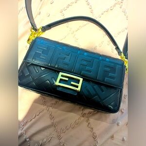 Womens black handbag with gold accents